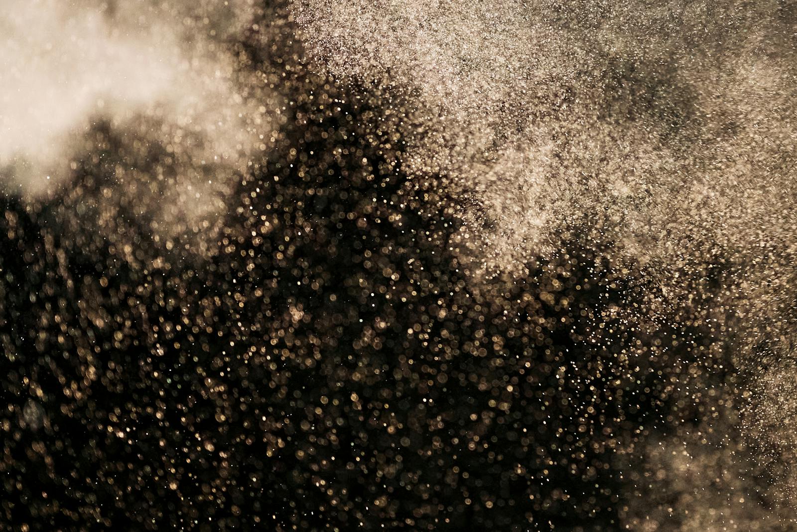 White Dust Particles on Black Background